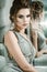 Beautiful woman with bright makeup in silver evening dress, hair