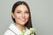 Beautiful woman brunette after bath holding white flowers and smiling