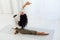 Beautiful woman brunette engaged in yoga asana gymnastics flexibility