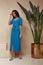 Beautiful woman brunette hair tanned skin makeup cosmetic wear fashion clothes summer collection blue knitted cotton dress on