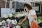 Beautiful woman buying vegetables at a farmers market