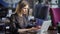 Beautiful woman in a cafe working with a laptop. Serious business lady, performs an order online during lunch break