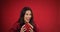 beautiful woman catches valentine's gift over red background