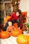 Beautiful woman with a child on the front porch with pumpkins au