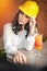 Beautiful woman civil engineer with yellow helmet taking a break in front of orange juice. Young female architect with white shirt