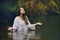 Beautiful woman in colorful forest stream