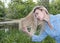 Beautiful woman combs long hair in the summer day on the river bank