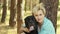Beautiful woman in the coniferous summer forest with her beloved dog Cane Corso black