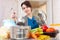 Beautiful woman cooking veggie soup with laddle