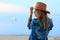 Beautiful woman in cowboy wild west style, cowboy hat and jeans jacket, fashion portrait photosession, advertising, sea view lands