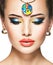 Beautiful woman with creative bright colored make-up.