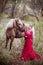 Beautiful woman in crown, blonde with horse. Princess in fairy tale.