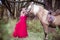 Beautiful woman in crown, blonde with horse. Princess in fairy tale