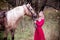 Beautiful woman in crown, blonde with horse. Princess in fairy tale