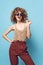 Beautiful woman curly hair fun fashion clothes studio sunglasses