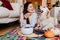 beautiful woman and cute golden retriever dog enjoying healthy breakfast at home, lying on the floor. healthy breakfast with tea,