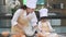 Beautiful woman and cute little Asian boy with eyeglasses, chef hat and apron playing and baking bakery in home kitchen funny. Hom