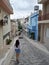Beautiful woman in cute streets of Agios Nikolaos, Crete, Greece. Traveling to Europe.
