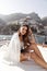 beautiful woman with dark hair in elegant clothes posing on the yacht against the backdrop of the city Positano