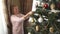 Beautiful woman decorates the Christmas tree