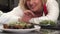 Beautiful woman decorating mussels dish on a plate preparing food at home