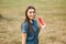 Beautiful woman in denimdress hold slice of watermelon in hands. Background of park