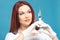 Beautiful woman doctor cosmetologist holding syringe with solution for beauty injections. isolated female studio portrait