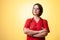 Beautiful woman doctor with stethoscope, wearing red scrubs looking confident hero-shot