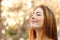 Beautiful woman doing breath exercises with an autumn background