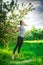 Beautiful woman doing yoga outdoors On green grass