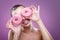 Beautiful woman with donuts, his two eyes are pink donut