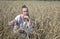 Beautiful woman dress in the field of ripe ears of cereals