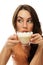 Beautiful woman drinking cappuccino coffee looking