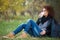 Beautiful woman drinking coffee under tree