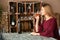 Beautiful woman drinking tasty wine at table in bar