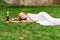 Beautiful woman drinking wine outdoors. Portrait of young blonde beauty in the vineyards having fun, enjoying a glass of