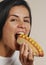 Beautiful woman eating hotdog