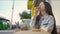 Beautiful woman eating pizza on street. Media. Woman snacking on pizza for lunch outside cafe. Young woman eats pizza on