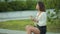 Beautiful woman eating salad sitting in a park