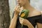 Beautiful woman eating wild raspberry in the forest