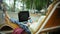 Beautiful woman eats an ice cream and works on a laptop on a wooden bench in the park