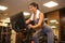 Beautiful woman is engaged on a stationary bike in the gym