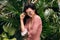 Beautiful woman enjoy travel lifestyle in tropical forest wearing sunglasses and summer dress.