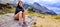 Beautiful woman enjoy view of landscape of gras field, mountain range in Ordesa national park, Pyrenees, Spain