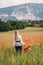 Beautiful woman enjoying nice day in poppy field