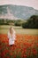 Beautiful woman enjoying nice day in poppy field