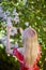 Beautiful Woman Enjoying the Smell of Lilac. Cute Model and Flowers.