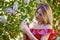 Beautiful Woman Enjoying the Smell of Lilac. Cute Model and Flowers.