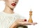 Beautiful woman with evening make-up holding a king chess piece