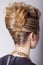 Beautiful woman with evening salon hairdo. Complicated hairstyle for party